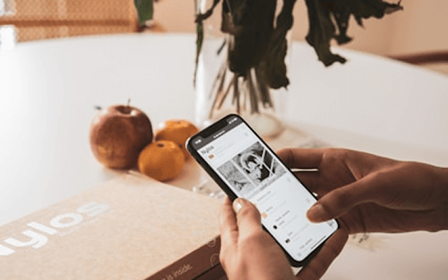FoodHat app on a phone with fresh fruit